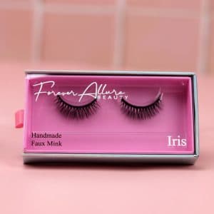 A single set of our Iris magnetic lashes on a pink background